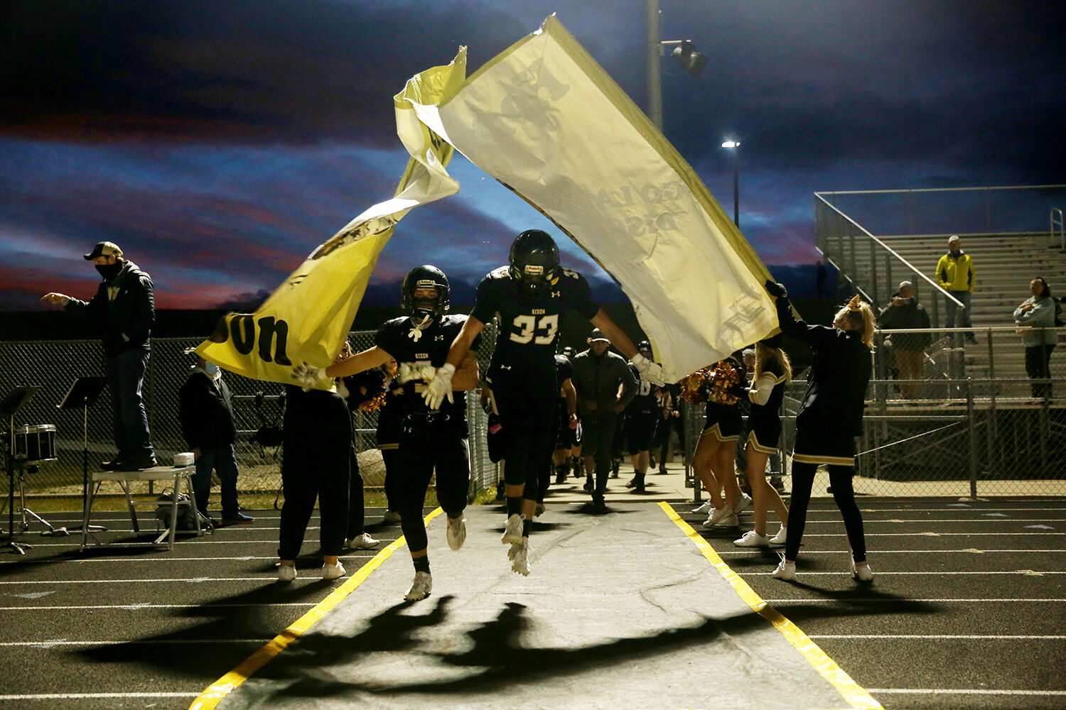 Hyrum Hatch, left, and Jace Skovgard burst through the BHS banner